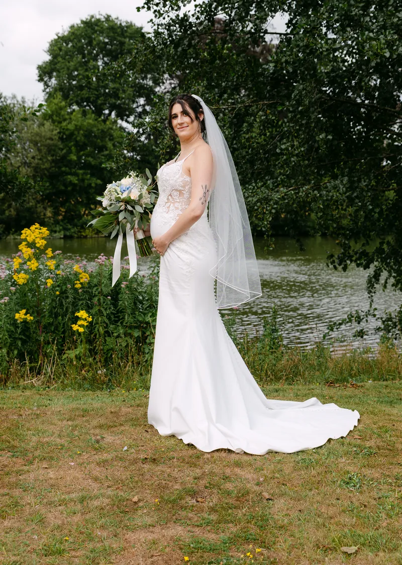 Bride by the lake at Chilston Park