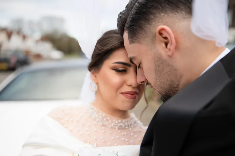 Close-up of the couple touching foreheads on their wedding day