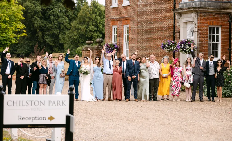 Wedding group photo by the entrance at Chilston Park Hotel
