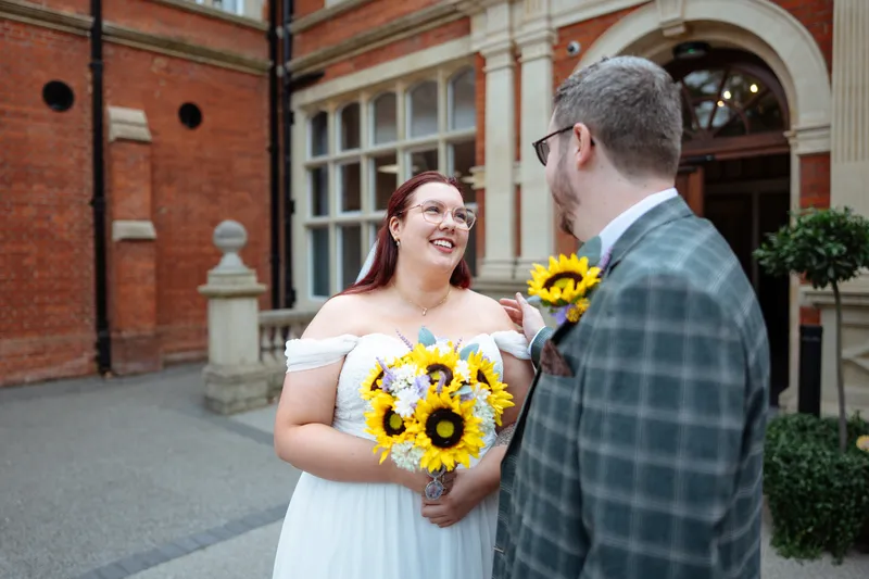 Bride and groom laughing outside Oakwood House