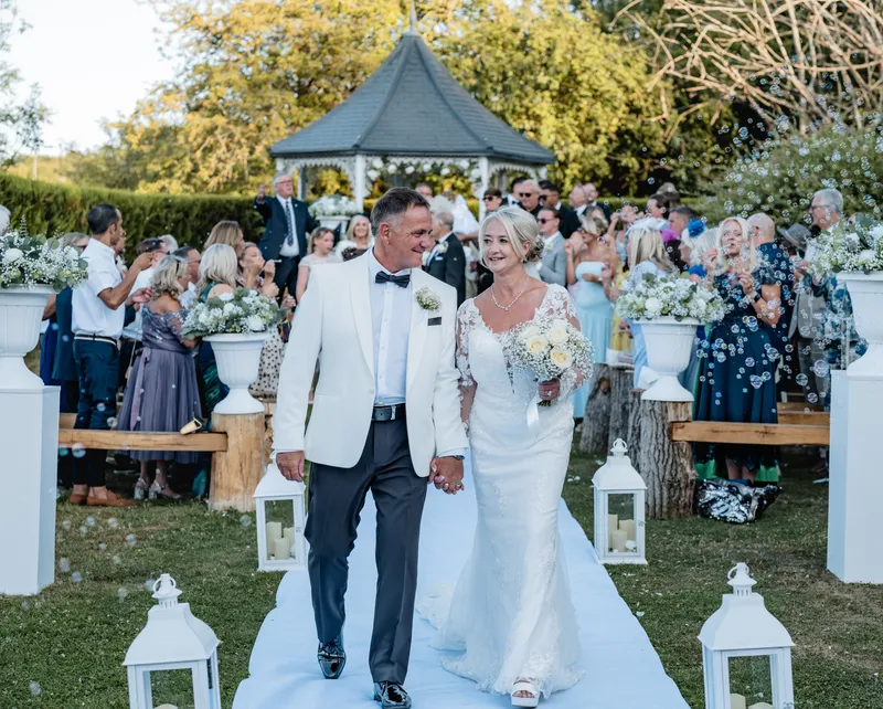 Couple walking back down the aisle at the Garden Gazebo ceremony, The Orchard