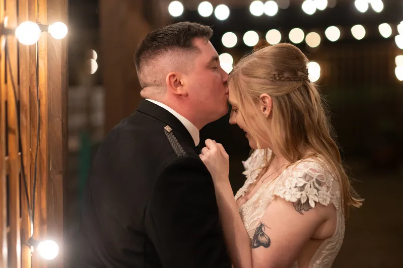 Couple embracing under festoon lights at a Kent wedding