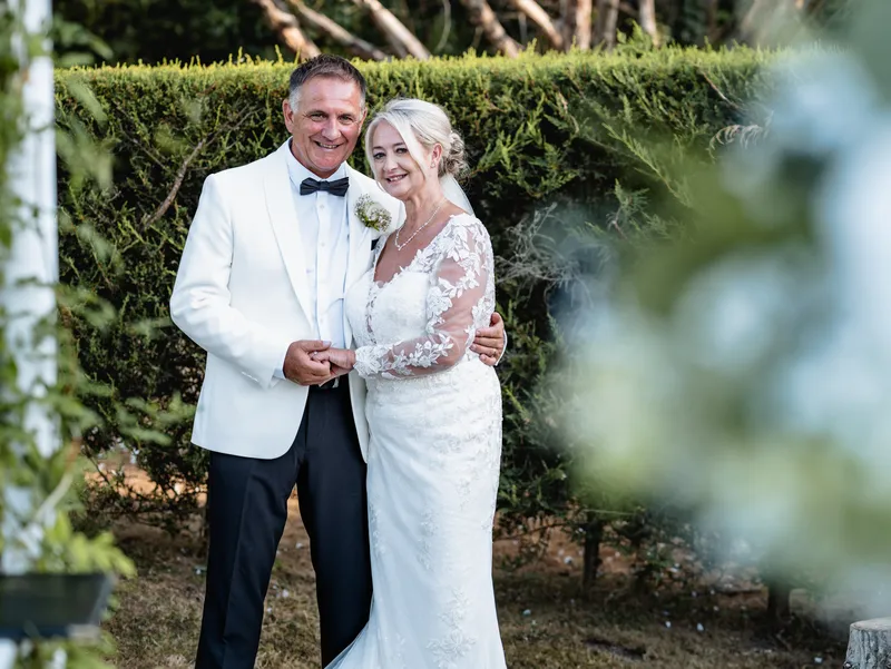 Bride and groom laughing in the gardens at The Orchard