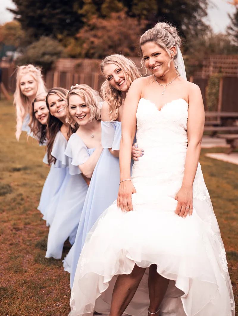 Bride and bridesmaids in pale blue in the garden