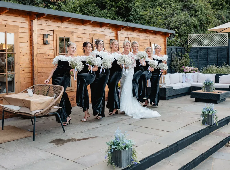 Bridesmaids on the terrace by Oak Lodge at The Orchard