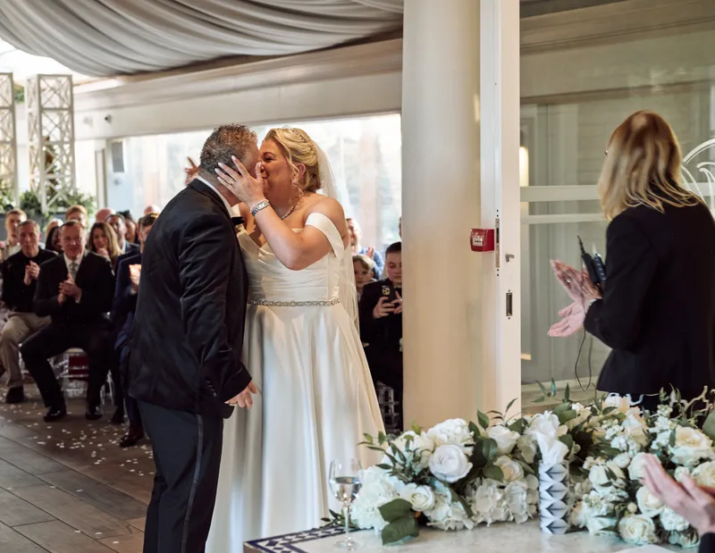 Couple's first kiss during the ceremony at Friern Manor