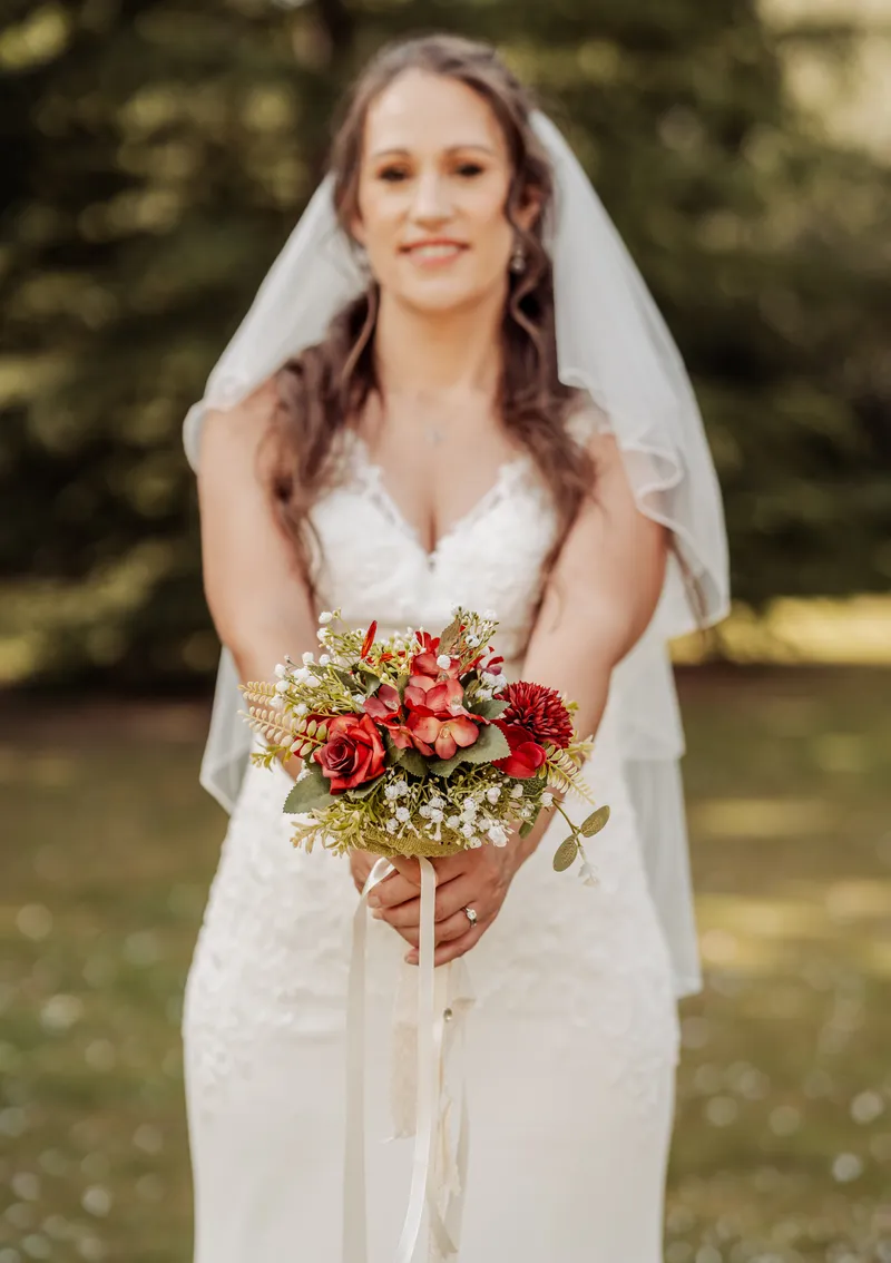 Bride holding her bouquet in the gardens at Oakwood House