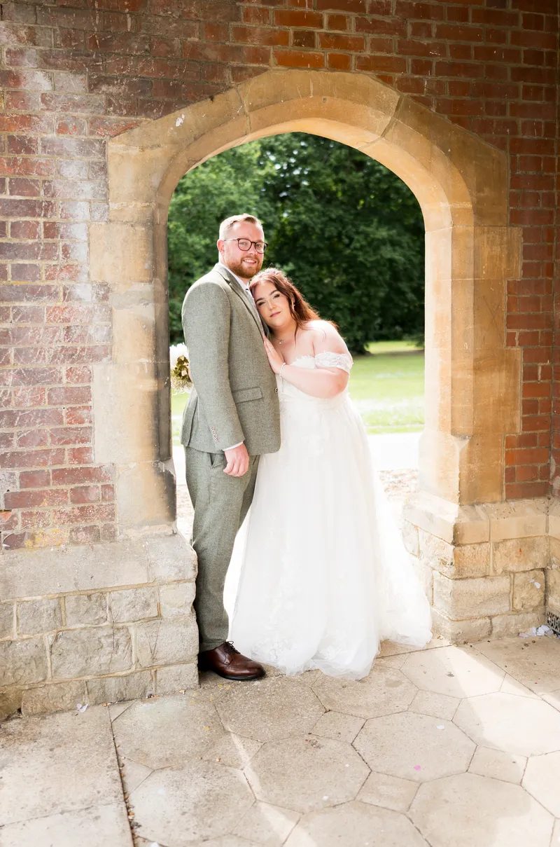 Quiet couple portrait in the brick arch at Oakwood House