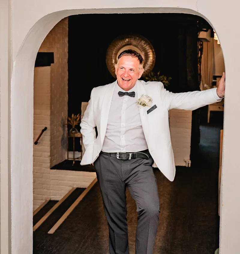Groom making a grand entrance at the reception at The Orchard