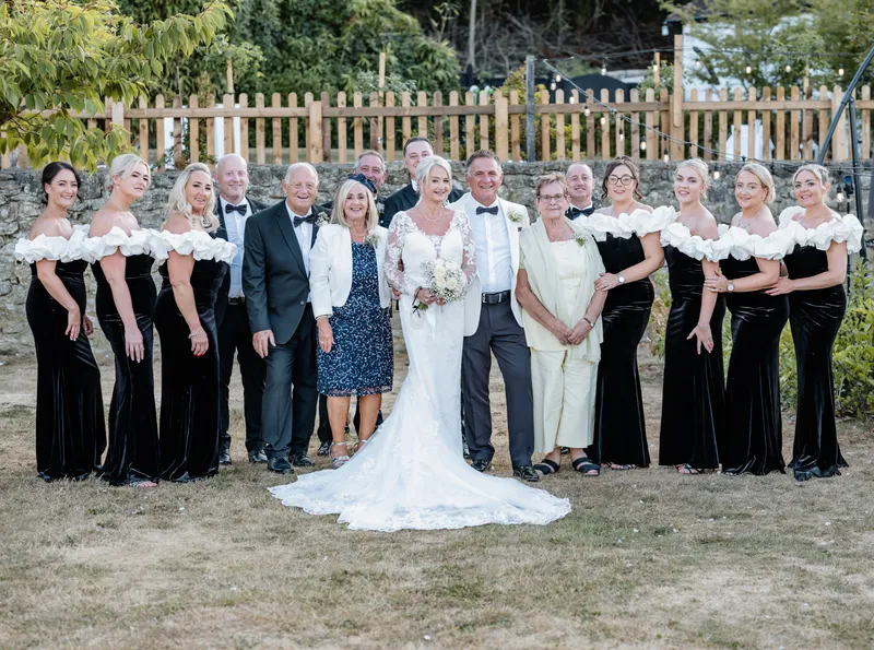 Wedding party group photo on the lawn at The Orchard