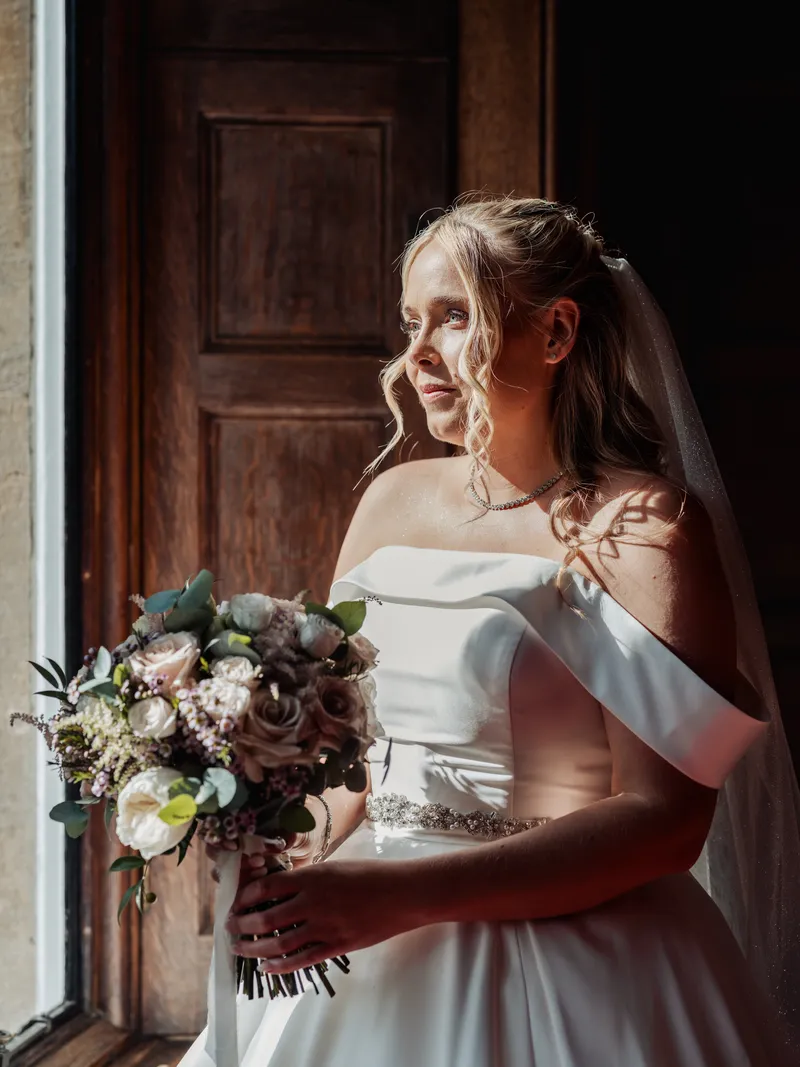 Bride in soft window light at Oakwood House