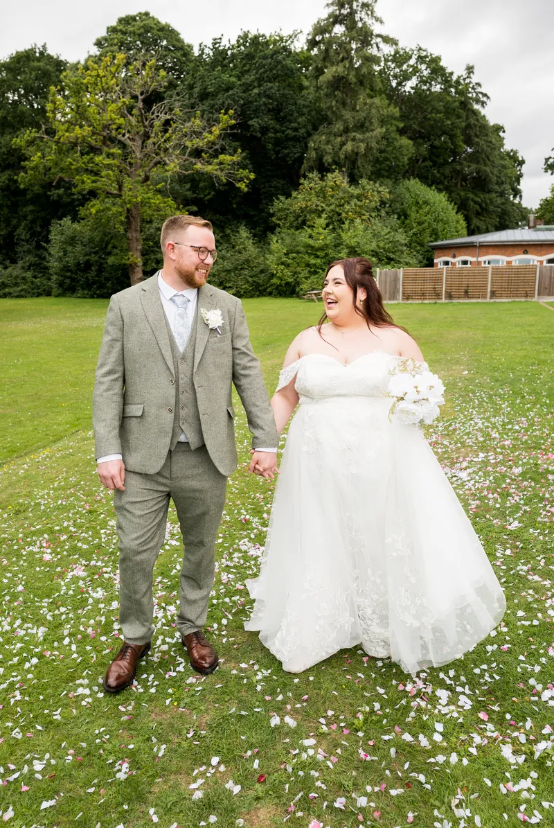Couple walking on the lawn at Oakwood House