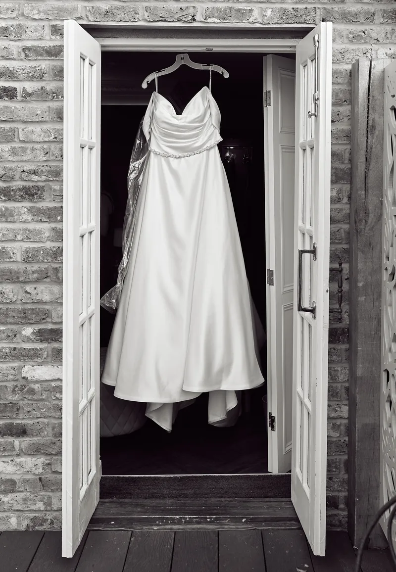 Wedding dress hanging in a doorway at Friern Manor