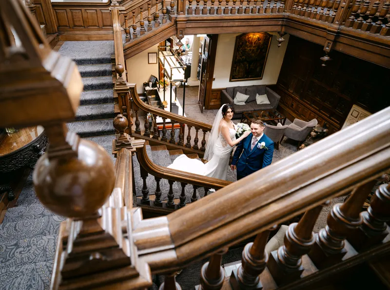 Couple seen from above on the wooden staircase at Chilston Park