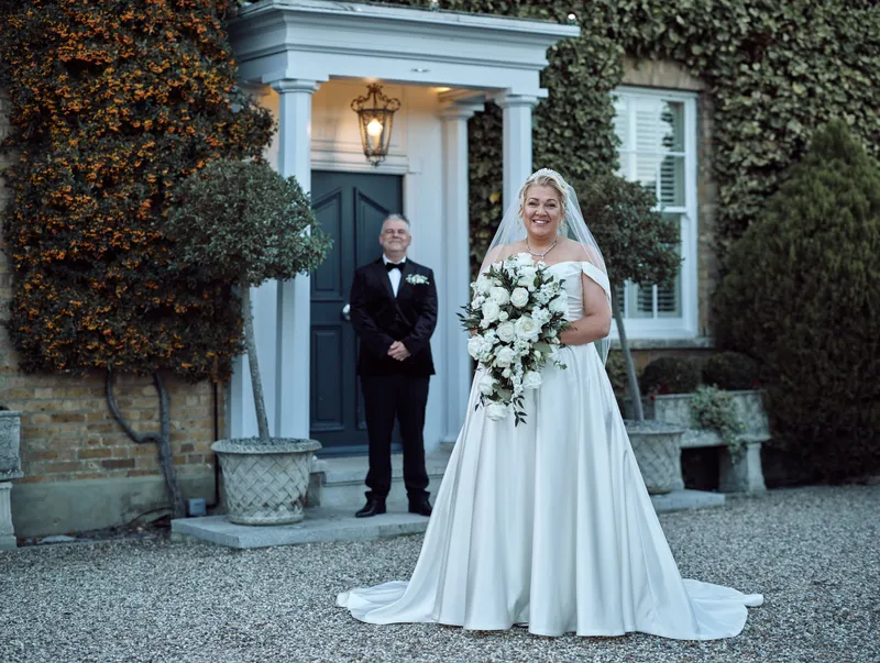 Bride and groom at the front door of Friern Manor, Brentwood