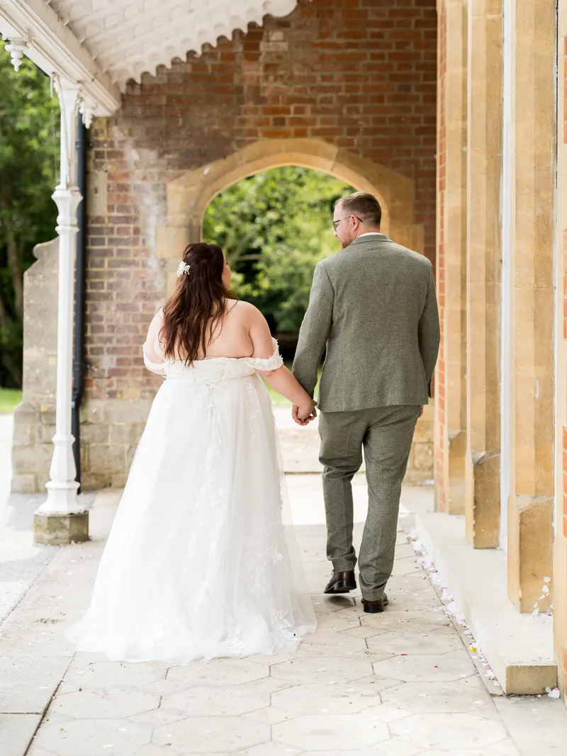 Couple walking along the covered walkway at Oakwood House