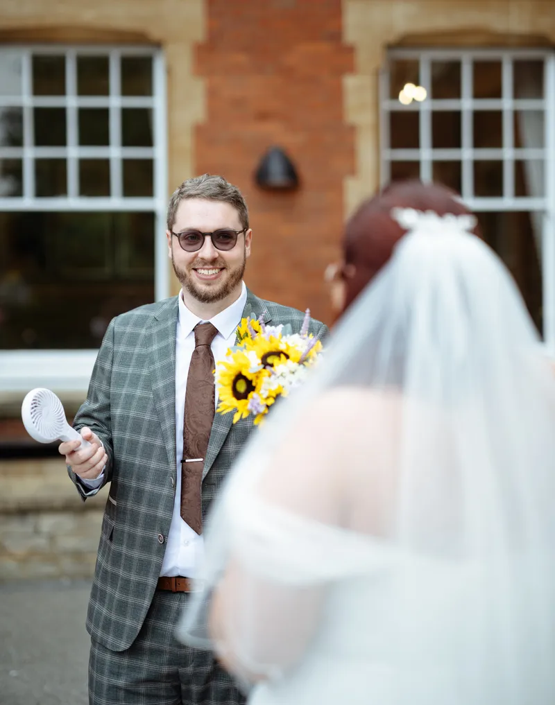 Groom smiling as he sees the bride at Oakwood House