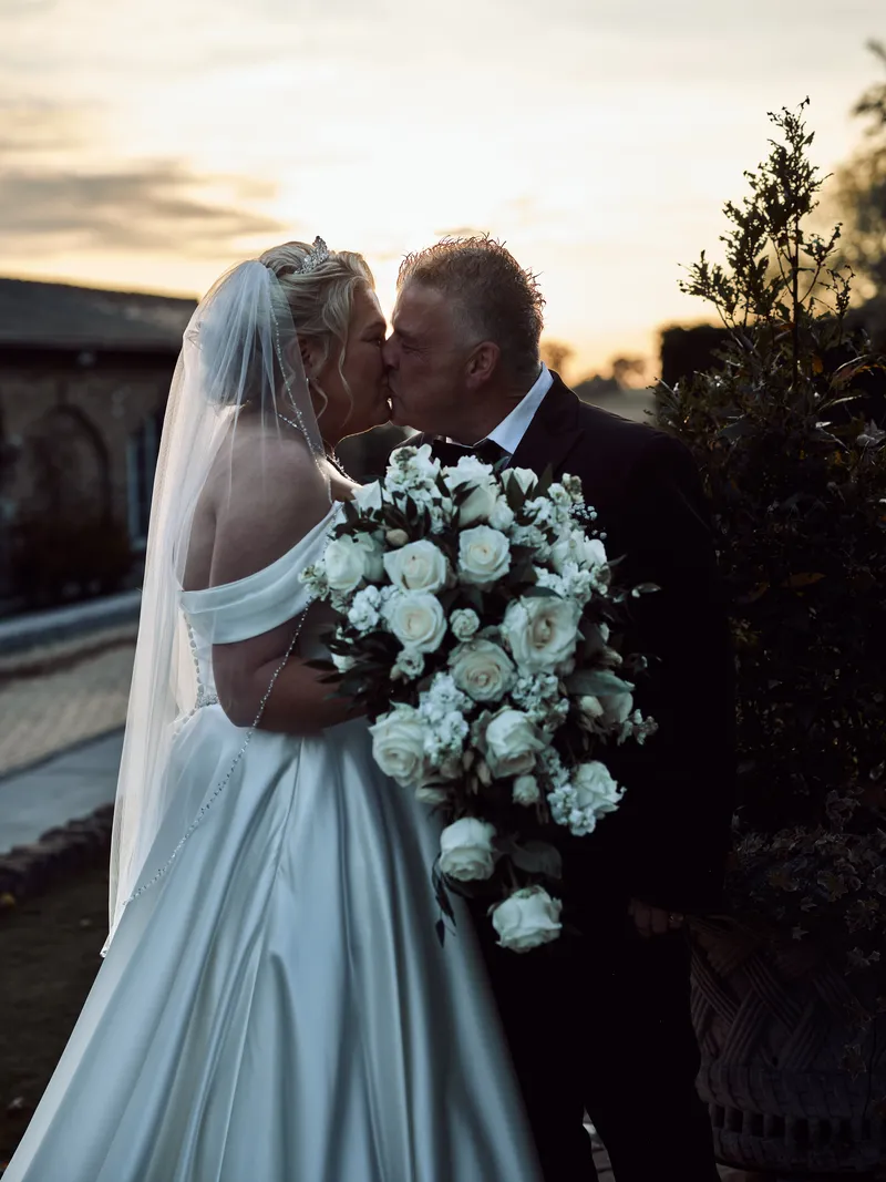 Couple kissing at sunset at Friern Manor
