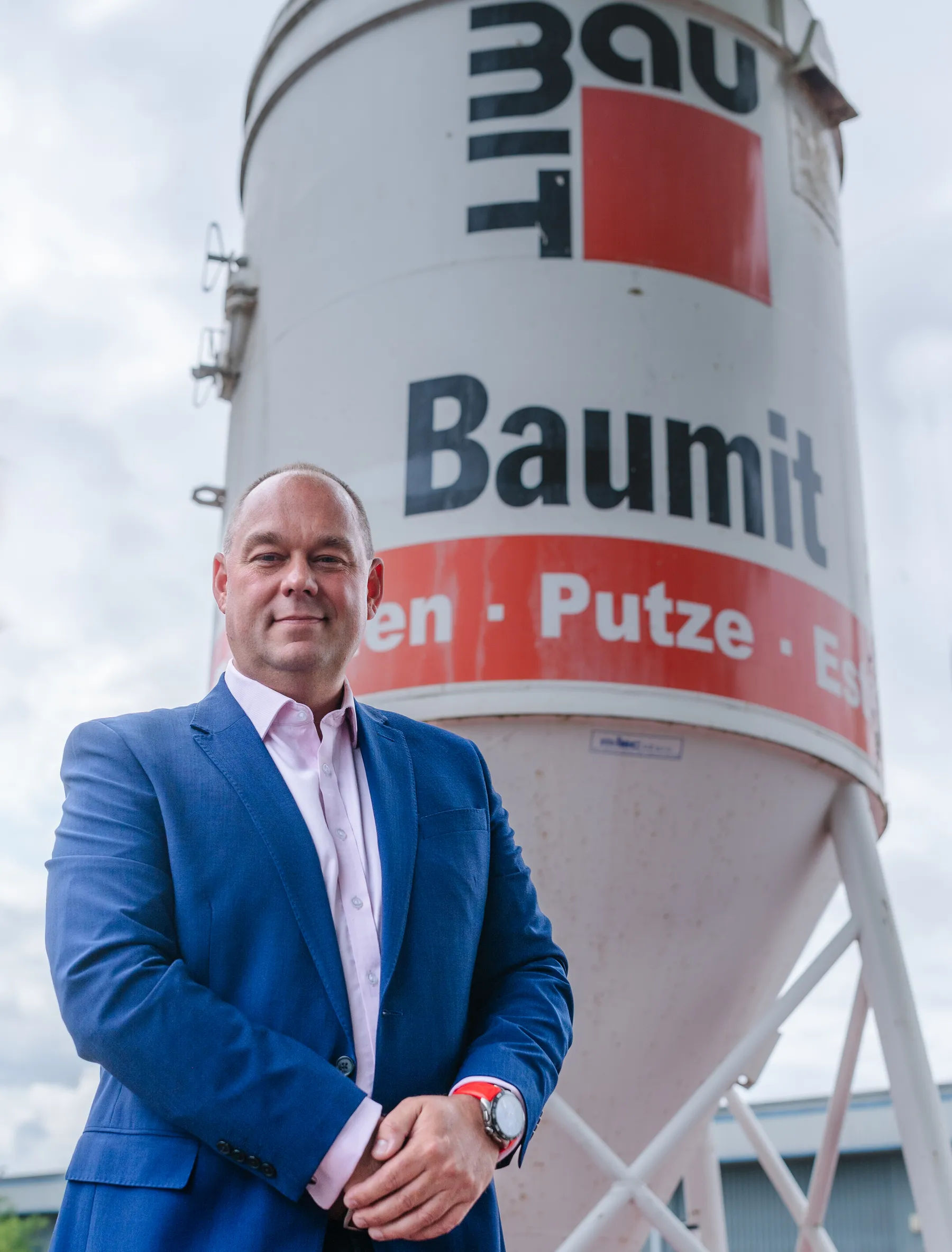 Corporate headshot with a projected office background