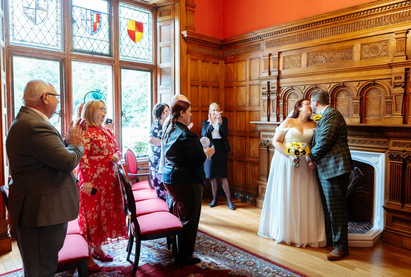 Wedding ceremony in a wood-panelled room at Oakwood House