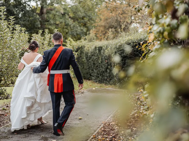 Couple walking along a garden path at Bradbourne House