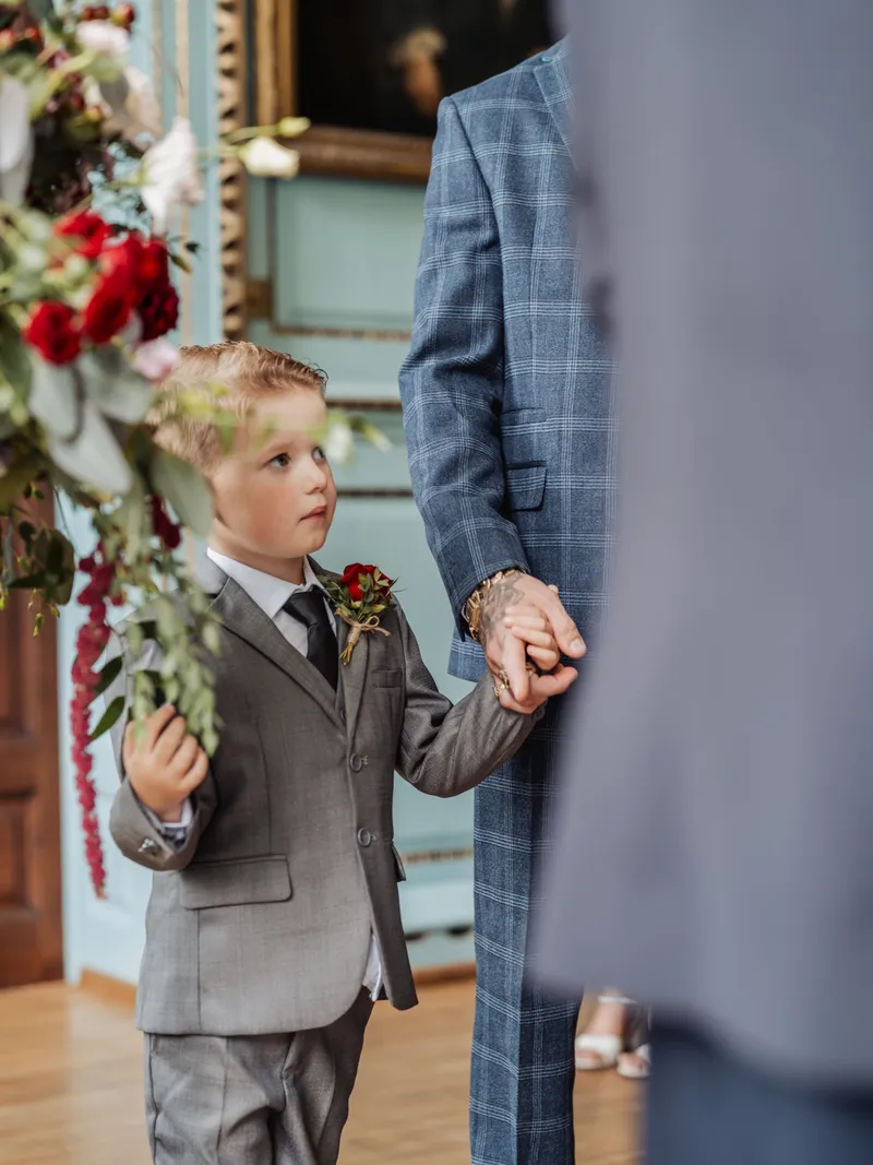 Page boy holding hands and looking up during the ceremony at Bradbourne House