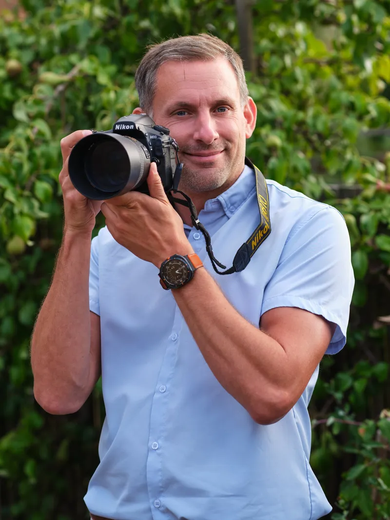 Chris Cork, wedding and portrait photographer in Maidstone, holding his camera