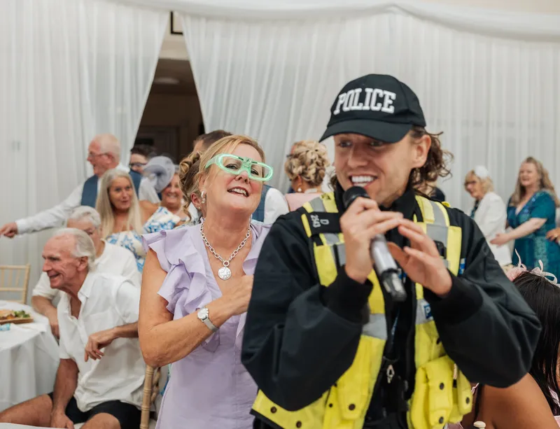 Guests laughing during the evening entertainment at a Kent wedding reception
