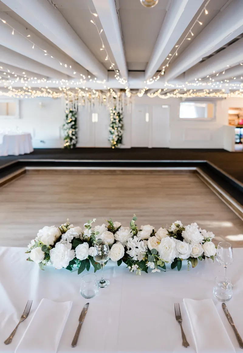 Top table flowers looking over the dance floor at The Orchard